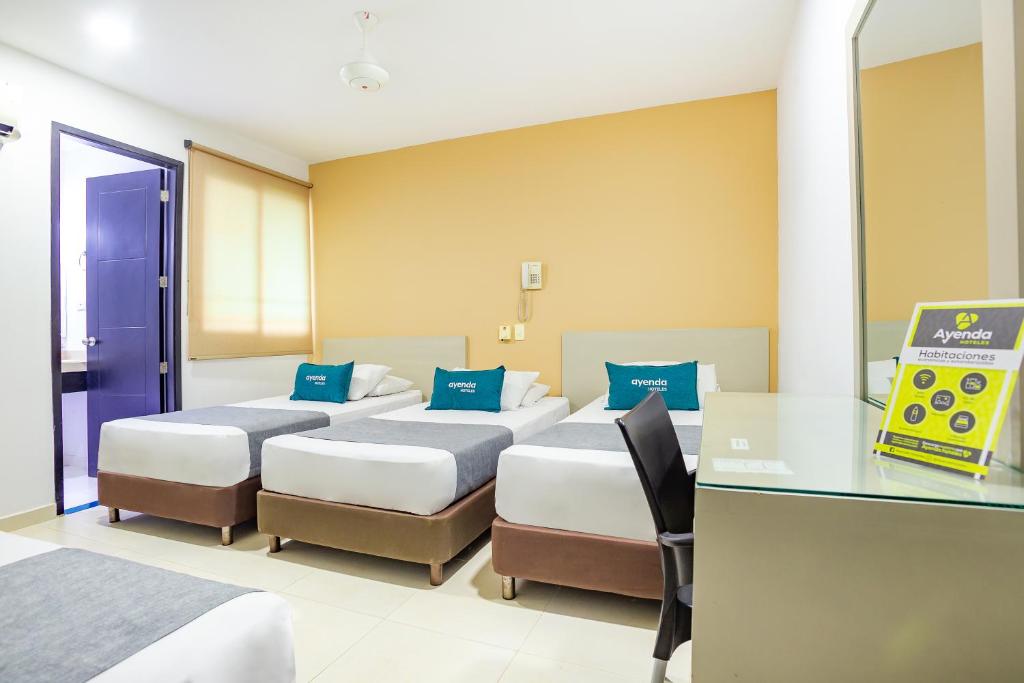 Postel nebo postele na pokoji v ubytování Hotel Ayenda Monteria Central