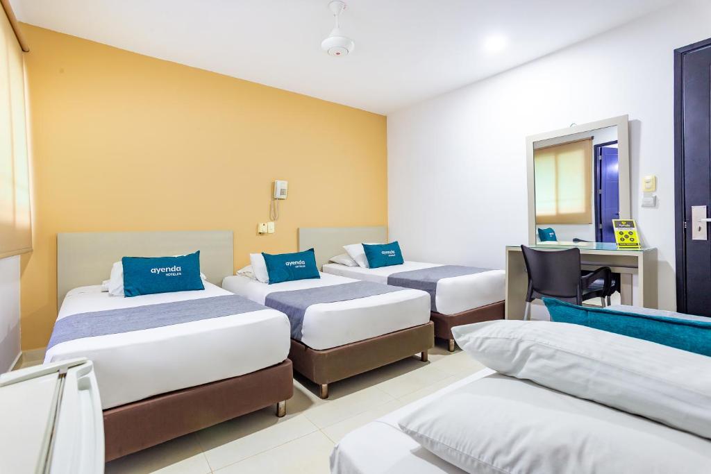 Postel nebo postele na pokoji v ubytování Hotel Ayenda Monteria Central