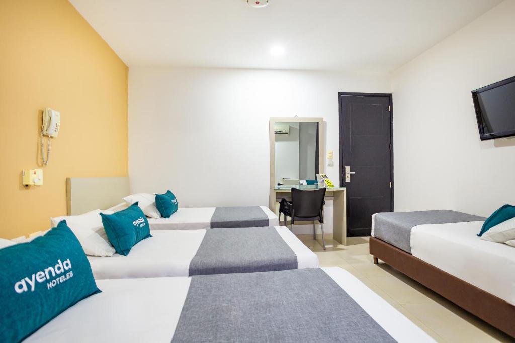 Postel nebo postele na pokoji v ubytování Hotel Ayenda Monteria Central