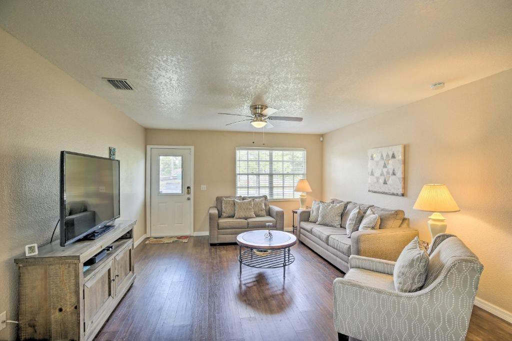 a living room with a couch and a flat screen tv at Modern North Port Gem Near Beaches, Golf, and Shops! in North Port