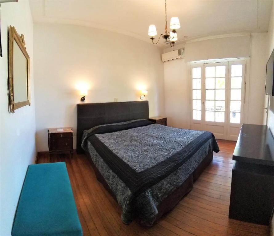 a bedroom with a large bed in a room at 515 St. Patrick Guesthouse Hotel in Buenos Aires