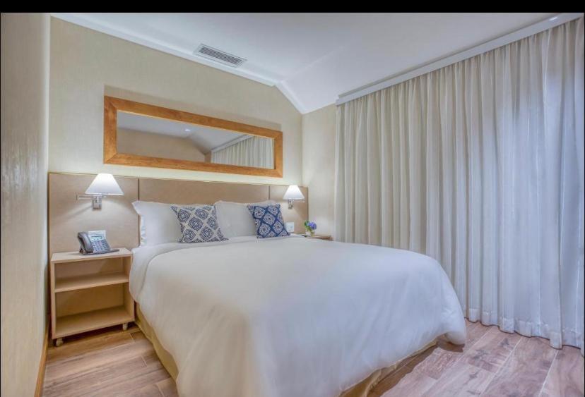 Ένα ή περισσότερα κρεβάτια σε δωμάτιο στο Apartamento em Resort & Spa Gramado