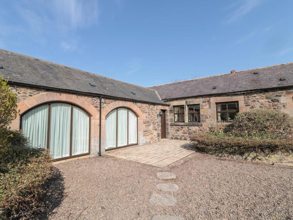 a brick house with two garage doors on it at Pansy Plot in Wooler