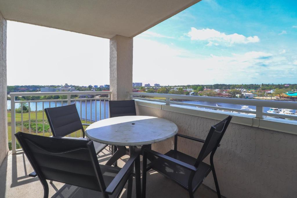 a table and chairs on a balcony with a view at Yacht Club Villas #1-701 condo in Myrtle Beach