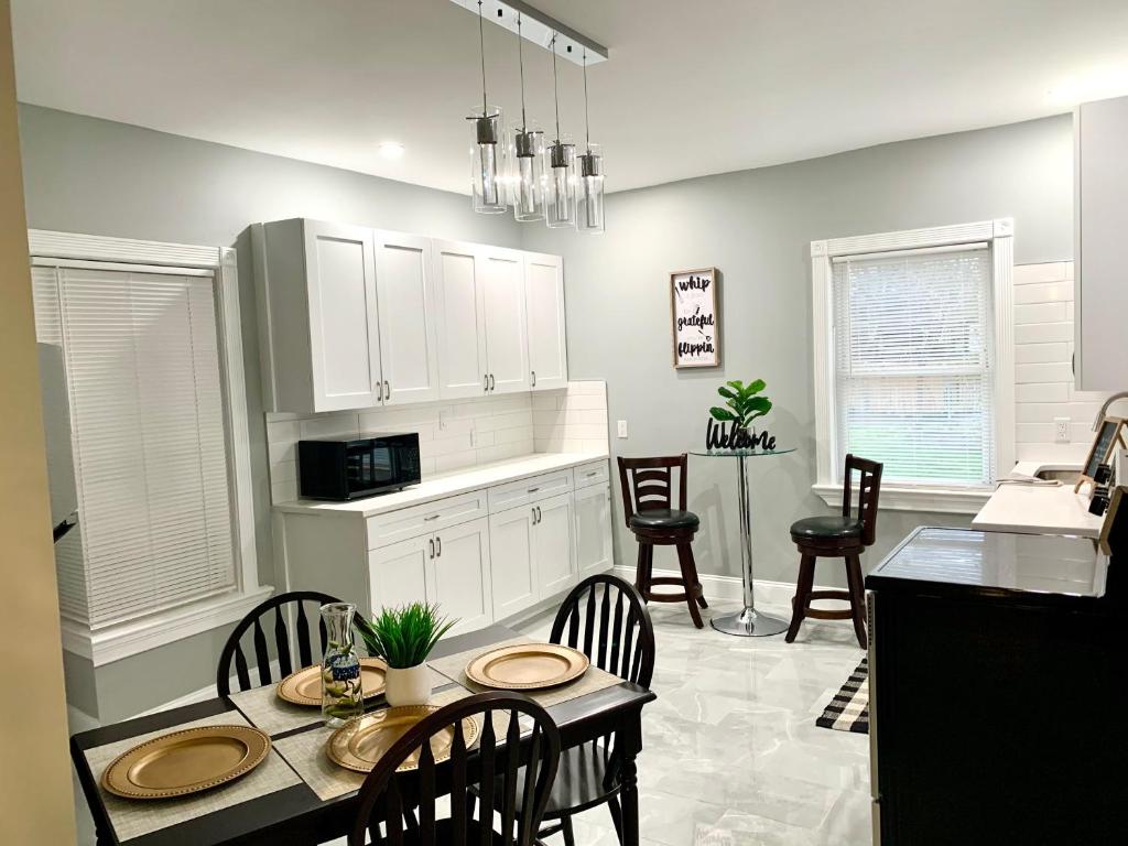 a kitchen and dining room with a table and chairs at The Roulette Duplex- With Private Yard & Parking, Minutes From Falls & Casino by Niagara Hospitality in Niagara Falls