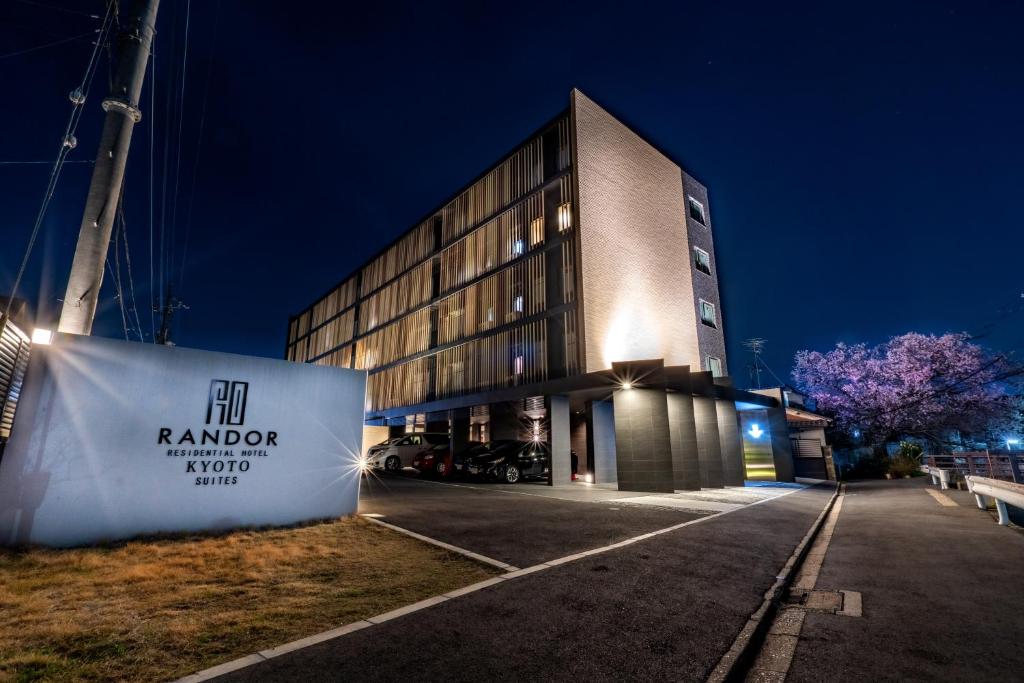 a building with a sign in front of it at Randor Residential Hotel Kyoto Suites in Kyoto