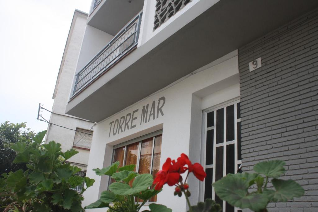 a white building with a true war sign on it at Hostal Torre Mar in Salou