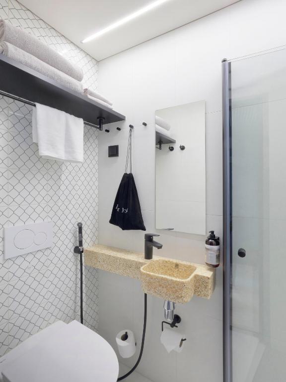 a bathroom with a toilet and a sink at VALO Hotel & Work Helsinki in Helsinki