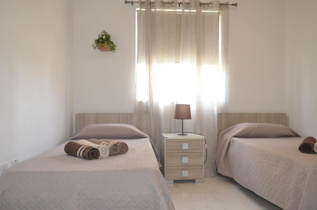 Postel nebo postele na pokoji v ubytování Lorenza Letting Apartment