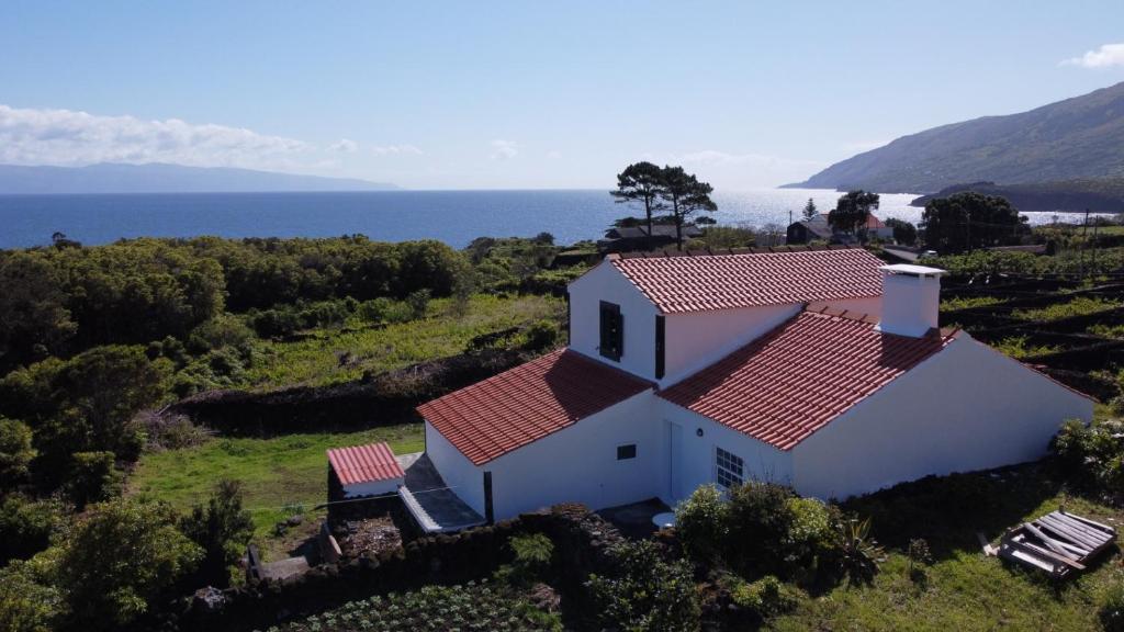 an aerial view of a white house with a red roof at The House in São Roque do Pico