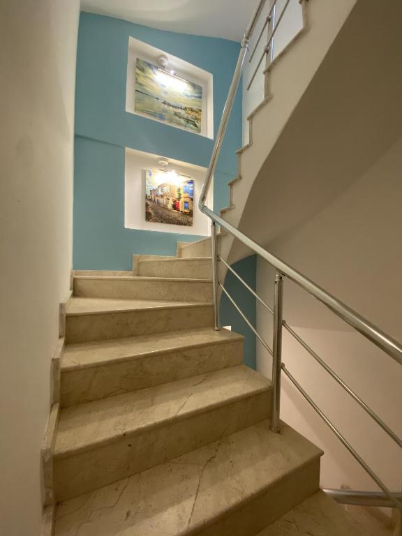 a staircase in a house with blue walls at Larimar Hotel Cesme in Çeşme