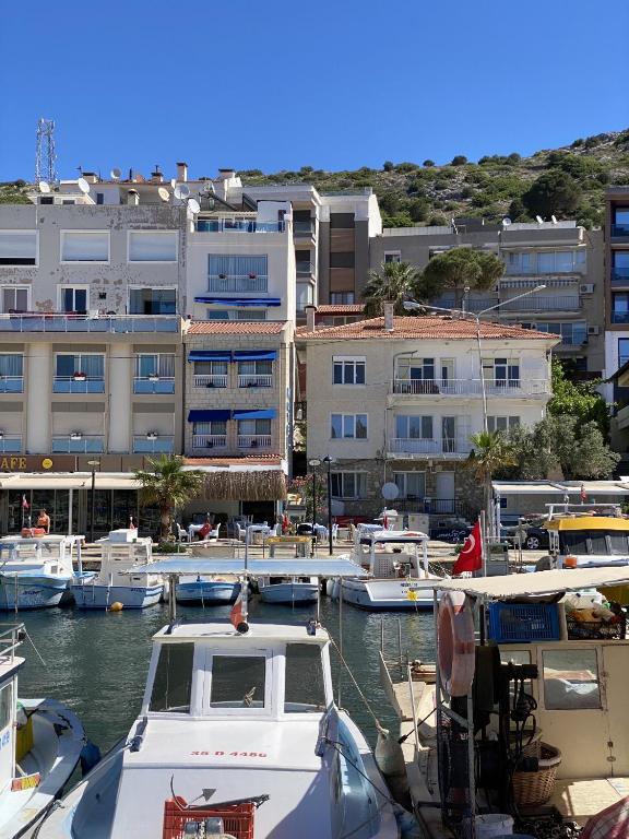 a group of boats docked in a marina with buildings at Larimar Hotel Cesme in Çeşme