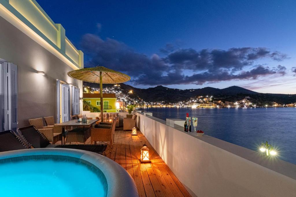 a pool on a balcony with a view of the water at Rementzo Apartment in Symi