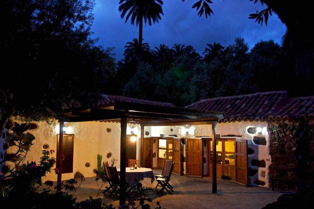 a patio of a house with a table and chairs at Casa Rural El Palmeral del Valle in Santa Lucía