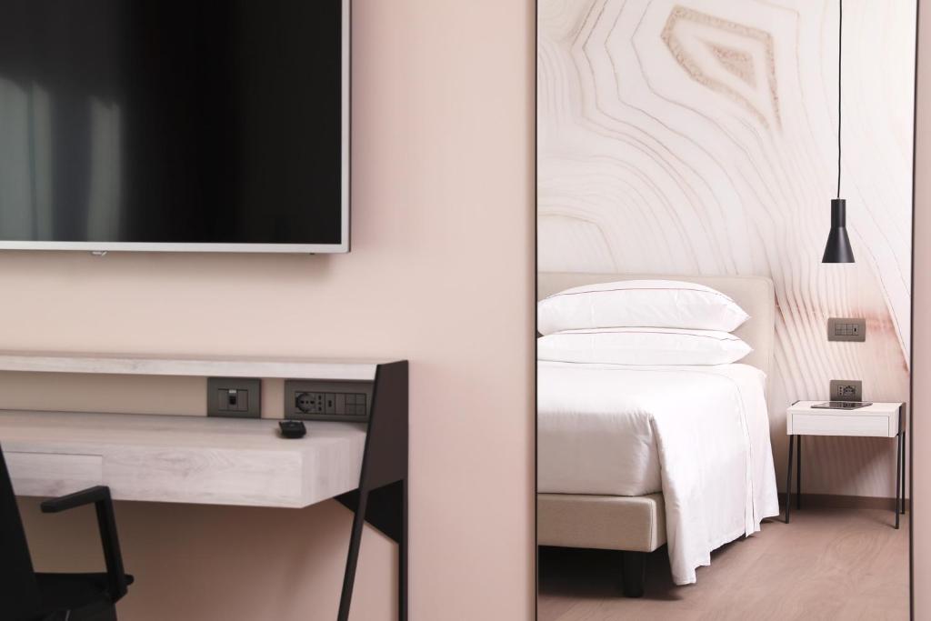 Postel nebo postele na pokoji v ubytování Hotel Veronesi La Torre