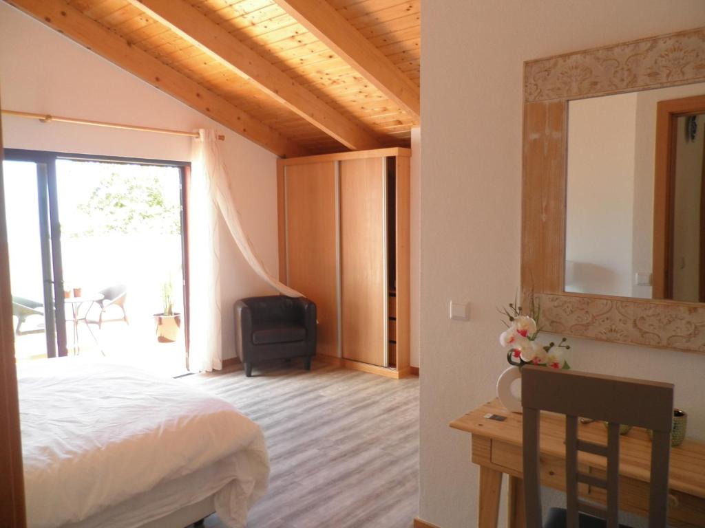 a bedroom with a bed and a desk and a mirror at Villa Luz II - NEW - Private Outdoor Area in Santa Cruz