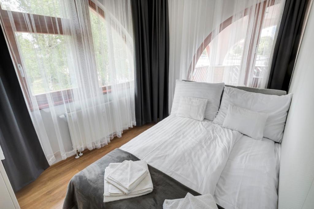 A bed or beds in a room at Fonyód Beach Apartment