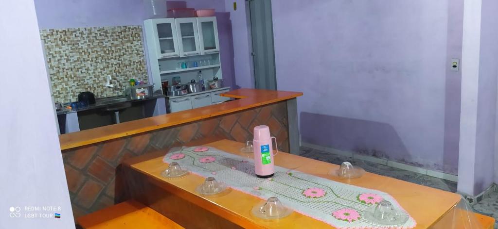 a table with a bottle of lotion on top of it at Chalé Cantinho Meu in Barreirinhas