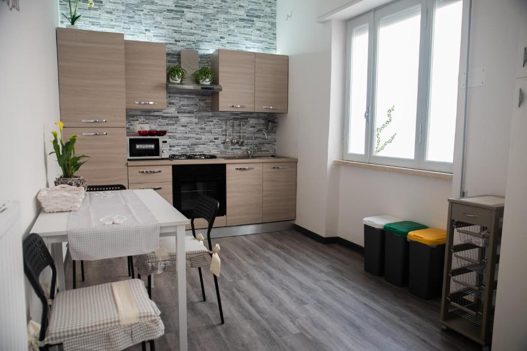 a kitchen with a table and chairs in a room at casa vacanze da gabriella tivoli in Tivoli