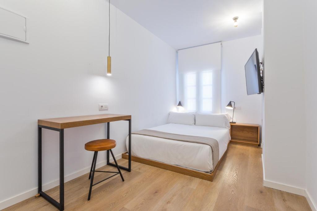 Postel nebo postele na pokoji v ubytování Uma Suites Atocha