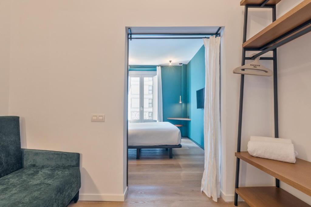Postel nebo postele na pokoji v ubytování Uma Suites Atocha