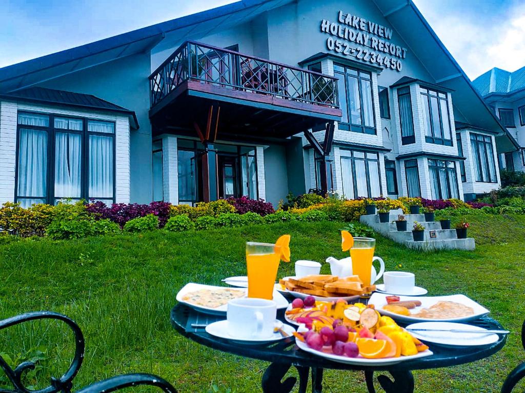 a table with food on it in front of a building at Lake View Holiday Resort in Nuwara Eliya