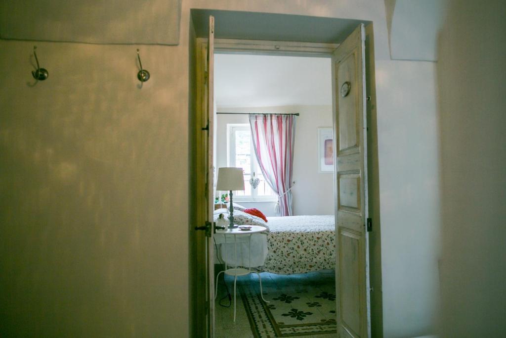 a room with a bedroom with a bed and a mirror at BB Le Gemme in Dolceacqua