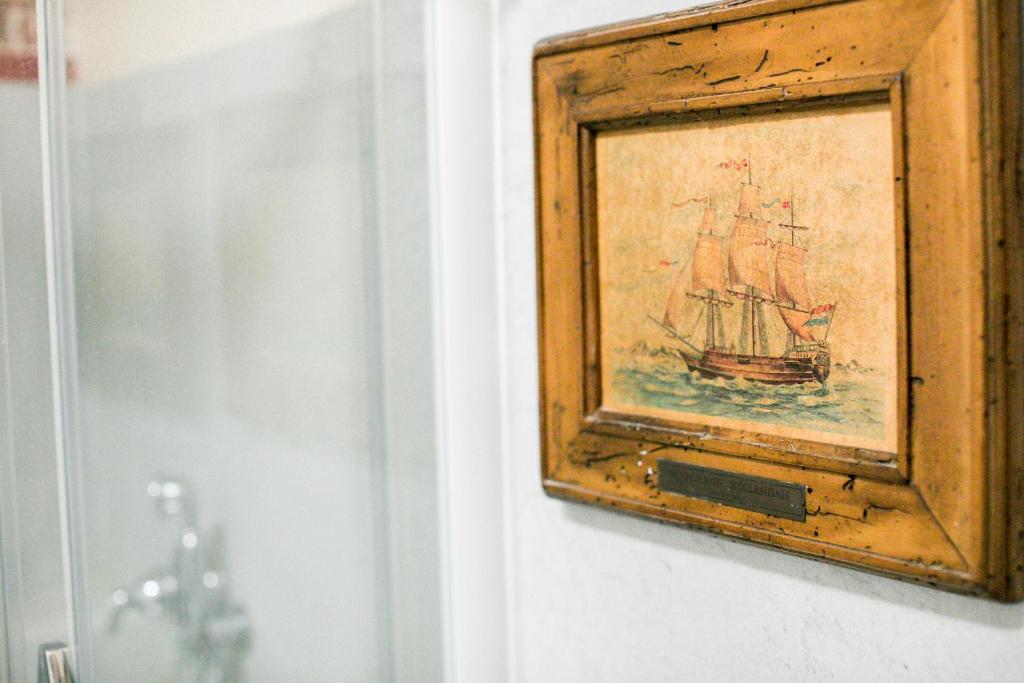a painting of a ship in a frame on a wall at BB Le Gemme in Dolceacqua