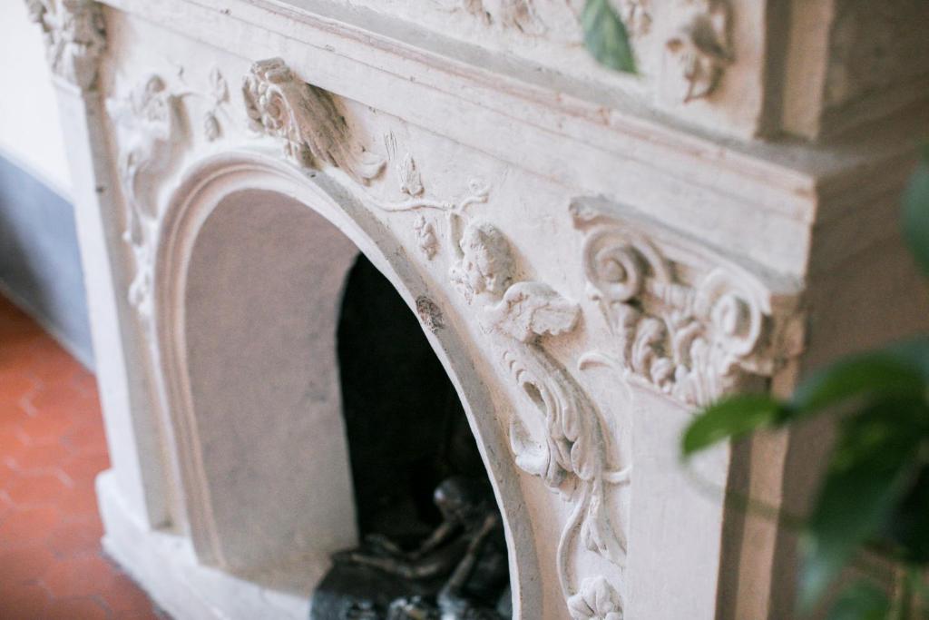a stone fireplace is shown with at BB Le Gemme in Dolceacqua
