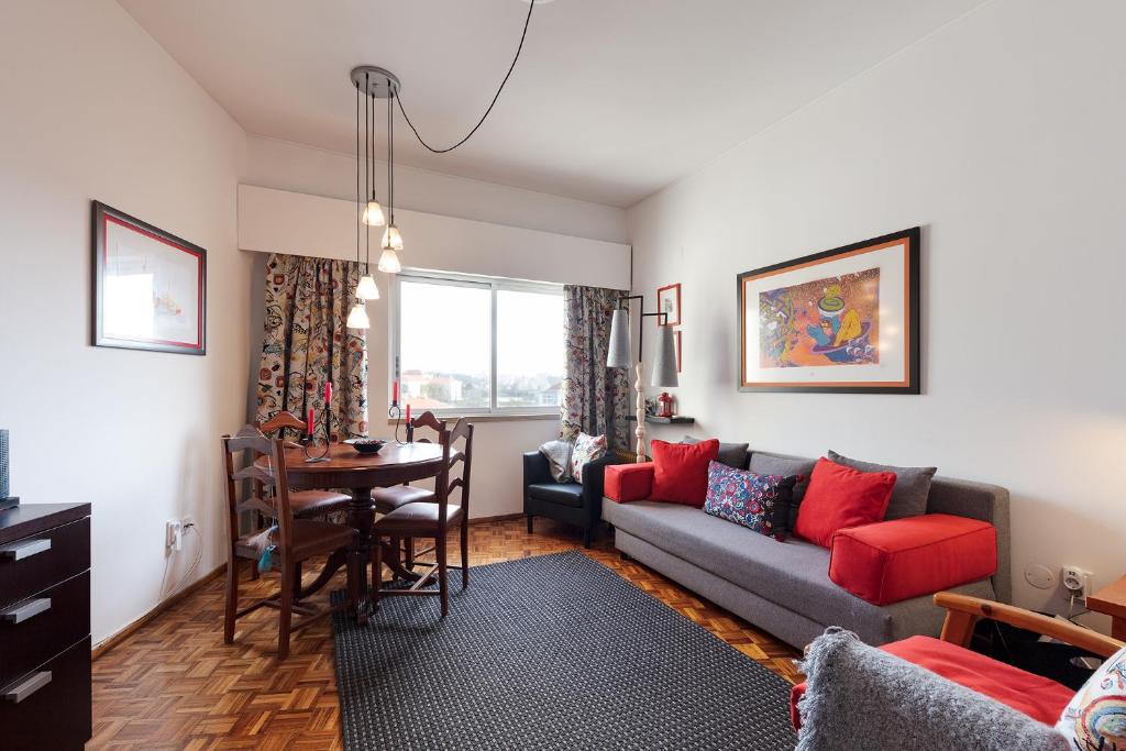 a living room with a couch and a table at Casa Da Tapada - Alcantara Riverview Apartment in Lisbon