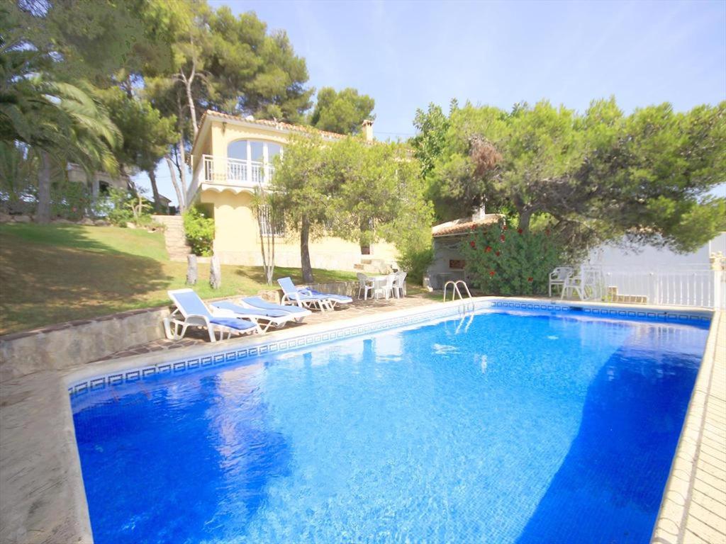 a large blue swimming pool in front of a house at Maria 10 in Jávea