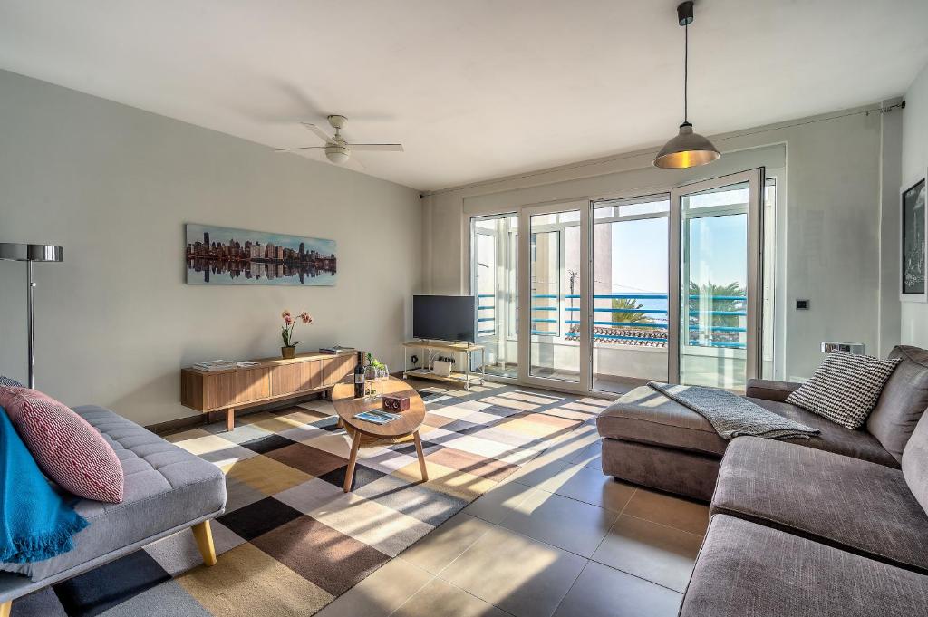 a living room with a couch and a table at Mar Apartment in Altea