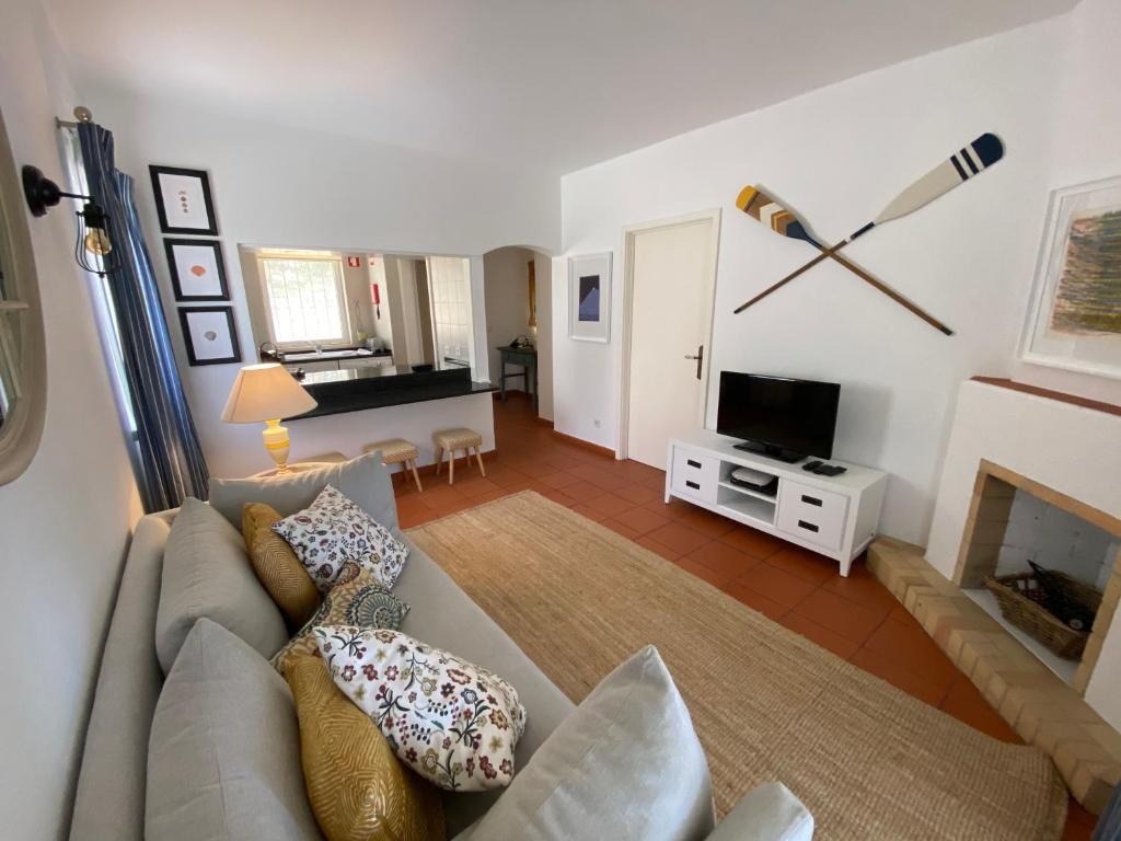 a living room with a couch and a fireplace at Quinta do Lago Golf in Quinta do Lago