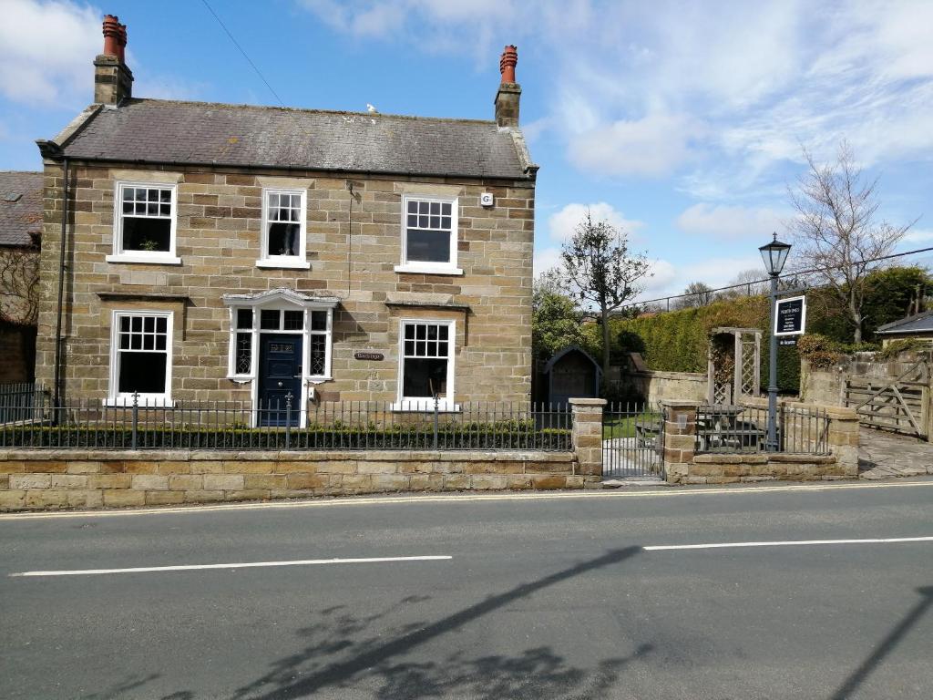 an old brick house on the side of the road at North Ings in Robin Hood's Bay