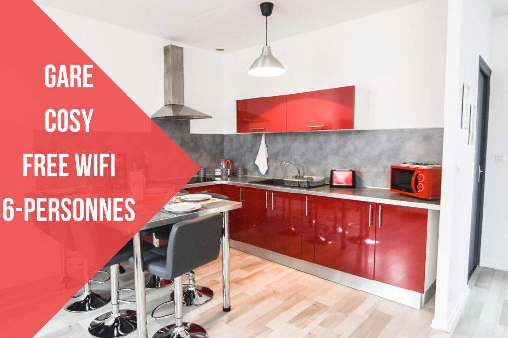 a kitchen with red cabinets and a red sign that reads careosity free wifi at Appartement "le Terminus " Gare-Cosy-Wifi 6 Personnes in Saint-Quentin