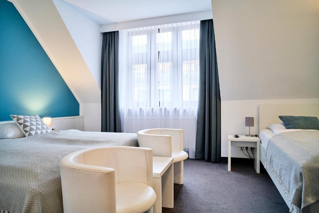 Postel nebo postele na pokoji v ubytování Brunnenhof City Center