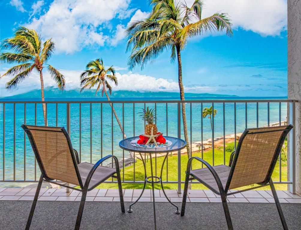a table and chairs on a balcony with a view of the ocean at Royal Kahana 309 1 Bedroom Condo condo in Kahana
