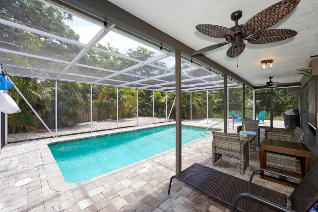 a swimming pool with a ceiling fan and a ceiling at Heated Pool Home - Close to Beaches, Restaurants & More! in Sarasota