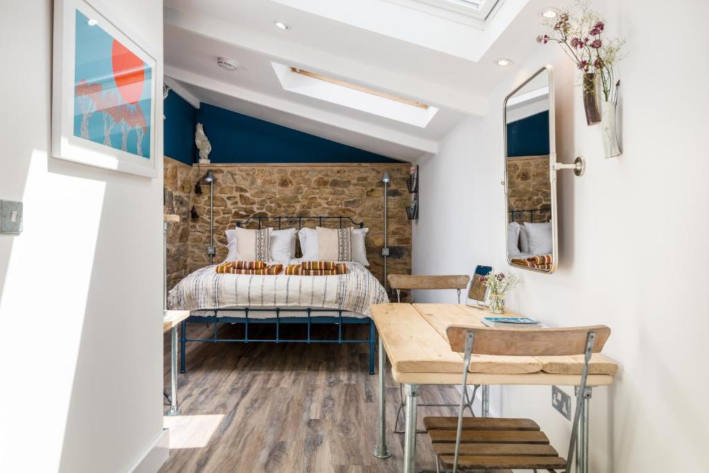 een slaapkamer met een bed en een tafel bij Penwyth House in Newquay