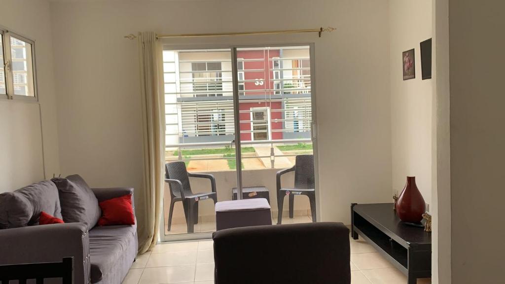 a living room with a couch and a table with chairs at Like Home Apartment !!! 2 bedrooms full apartment in La Ureña