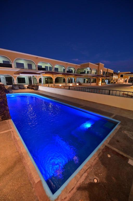 a swimming pool in front of a building at night at Hotel San Ignacio Inn in Torreón