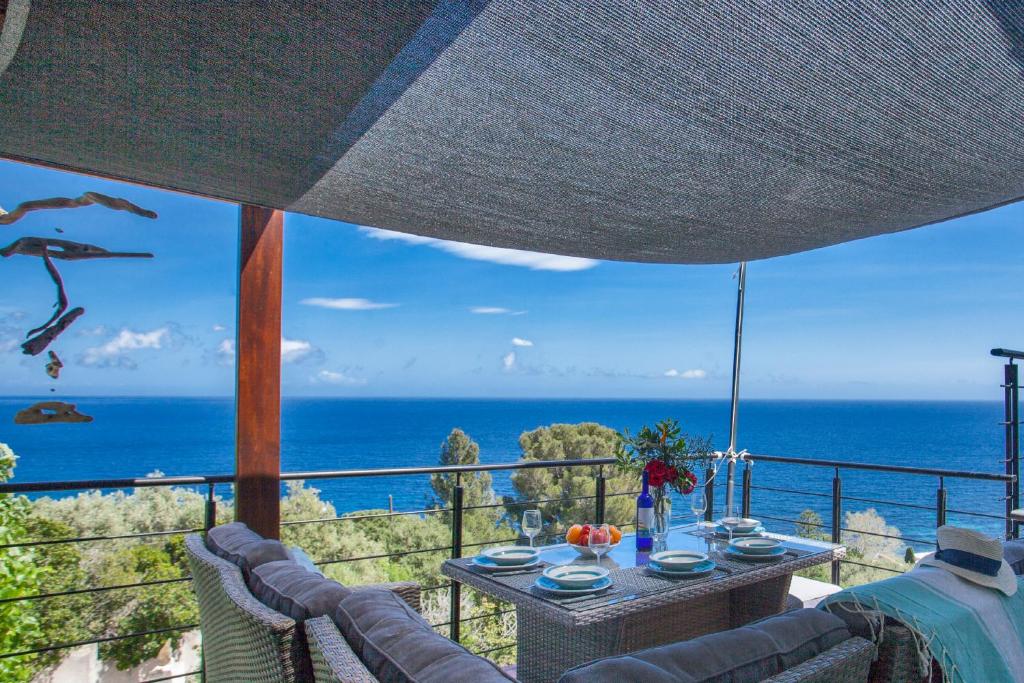 a view of the ocean from the balcony of a house at vita nova in Santa-Maria-di-Lota