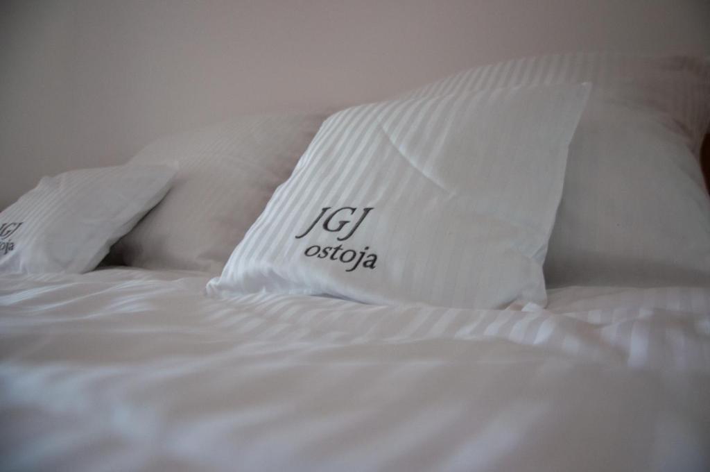 a white bed with two pillows on it at JGJ Ostoja in Puck