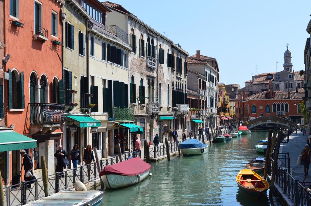 a canal in a city with boats and buildings at Hotel Locanda Salieri in Venice