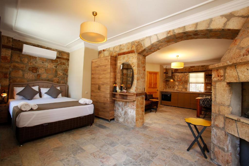 Castle Inn Boutique Hotel في أنطاليا: غرفة نوم بسرير في غرفة بها موقد