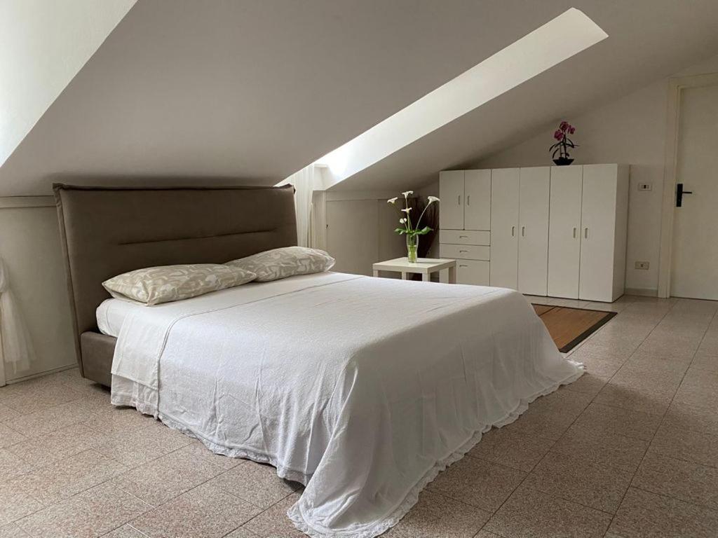 a bedroom with a large white bed in a attic at Casa vicino al mare in Rimini