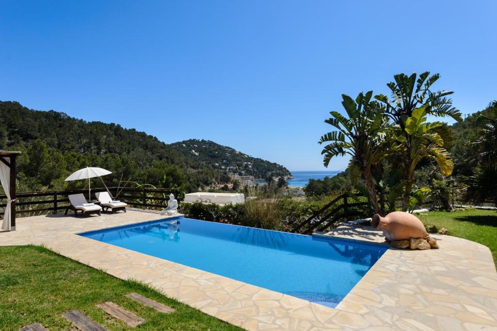 a swimming pool with a view of the ocean at Villa Can Sans in Cala San Vicente