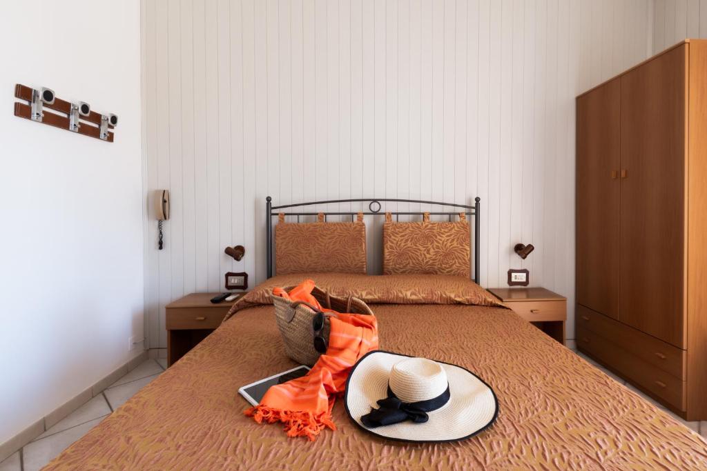 Postel nebo postele na pokoji v ubytování Albergo Rosa & Cosetta