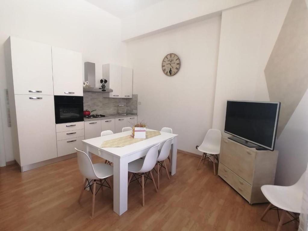 a white dining room with a white table and chairs at Casa Stella in Castel di Sangro