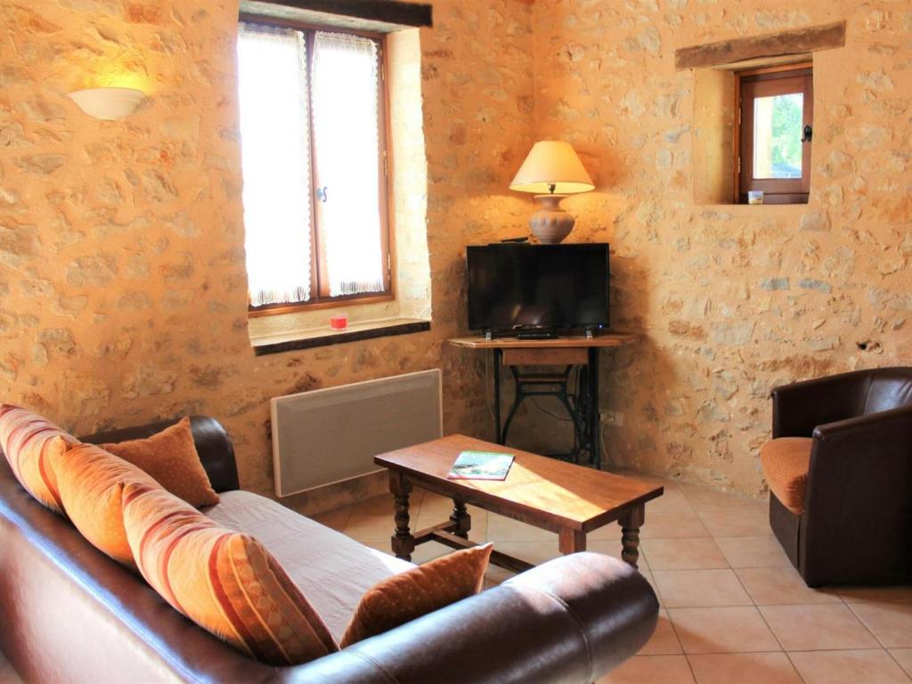 a living room with a couch and a table at Gîte Azerat, 4 pièces, 6 personnes - FR-1-616-138 in Azerat